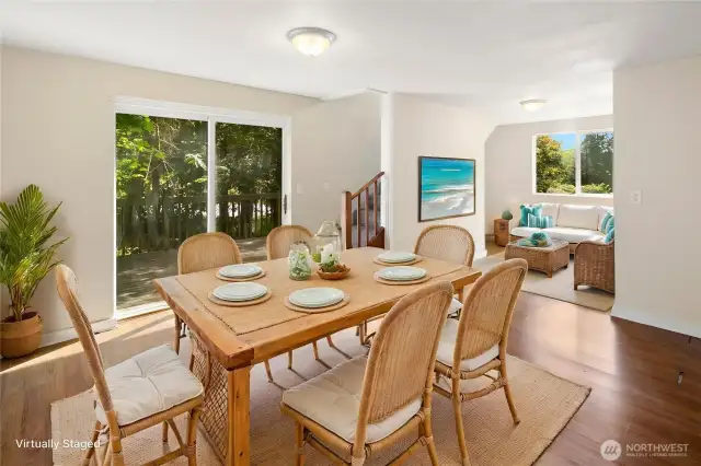 Dining room and den with virtual staging. Stairs lead to tower.