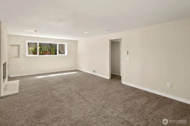 Lower level rec room with wood burning fireplace