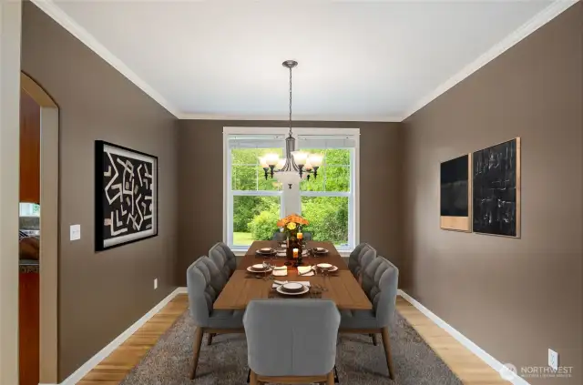 Formal dining room features large windows, crown molding and hardwood floors.