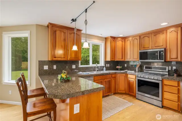 Kitchen offers extensive solid cherry cabinetry, granite countertops, stainless steel, and kitchen aid appliances.