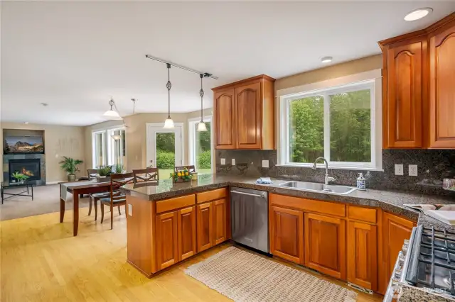 Enjoy the lovely, treed setting from the entire length of windows and doors.  Large eating nook as well as the eating bar at counter.