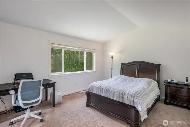 Double door entry to primary suite with vaulted ceilings, views to backyard, double closets, including walk-in,  and luxurious 5 piece bath.