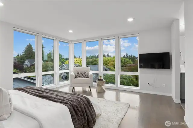 Sprawling primary suite with floor to ceiling windows