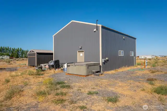 Rear of shop with hot tub and extra shed