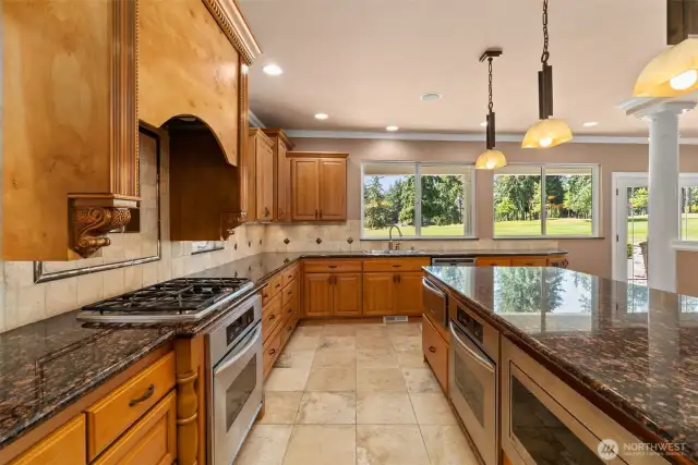 Gas range, double oven and warming drawer.