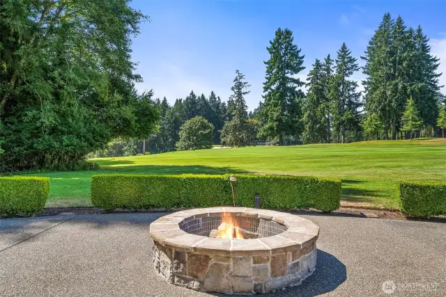 Gas firepit situated on oversized patio facing the course