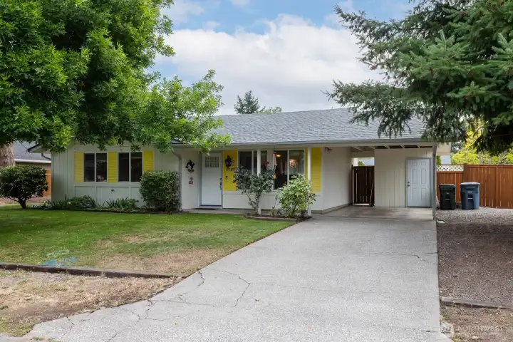 Charming curb appeal with cheerful shutters and welcoming entry.