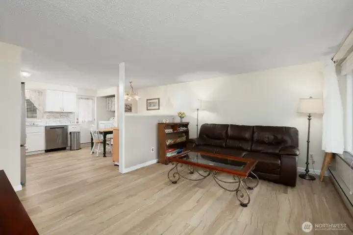 Enjoy new Luxury Vinyl Plank flooring throughout the living room and kitchen.