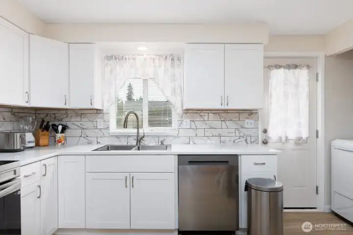 Enjoy a view of the beautiful backyard while washing dishes.
