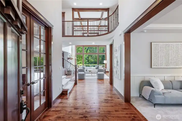 Step inside to elegance. Formal office to the left with glass pane French doors, and formal living room to the right. Straight ahead to the gorgeous Great room with floor-to-ceiling windows, and overhead breezeway on the 2nd floor.