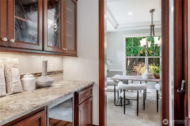 Butler's Bar with beverage fridge, and cabinetry.