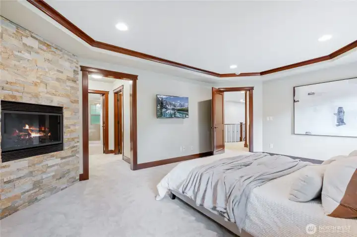 Sumptuous primary suite with cozy gas fireplace