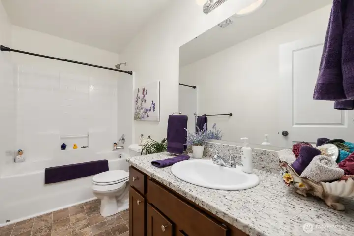 Main bath with granite slab counters