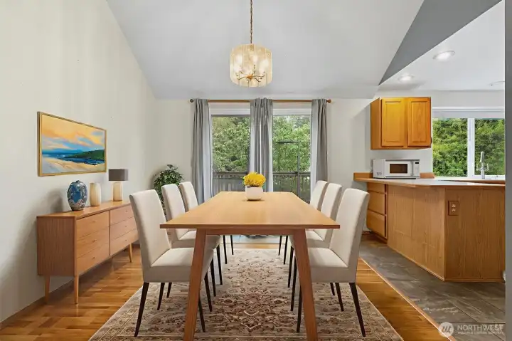 Dining room conveniently located between the kitchen and family room. Easy access to the deck through the sliding glass doors. Note: Virtually staged.