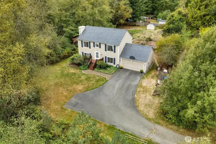Drone view of home and front and back yard space.