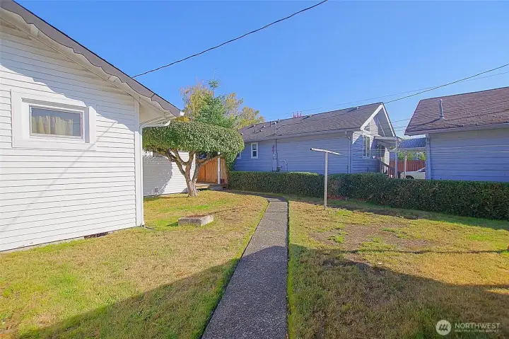 Paved walkway between garage and home