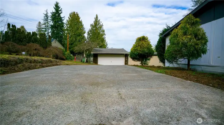 Large cement slab parking area plus oversized 2 car garage