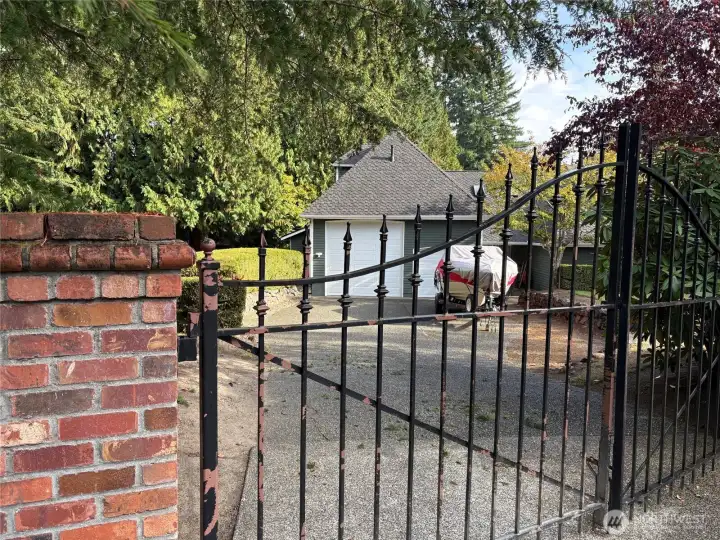 Both driveways have gates.  This is a view of additional garage with RV door.