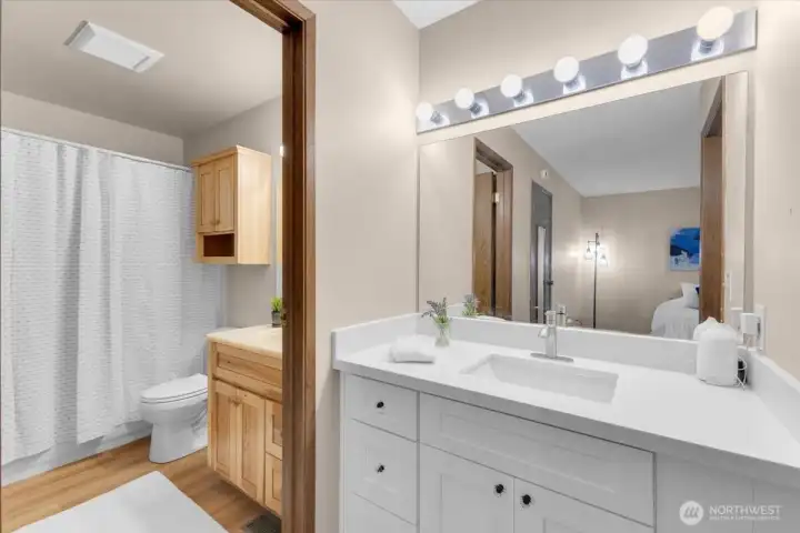 Attached primary bath with additional counter space outside of shower and toilet area