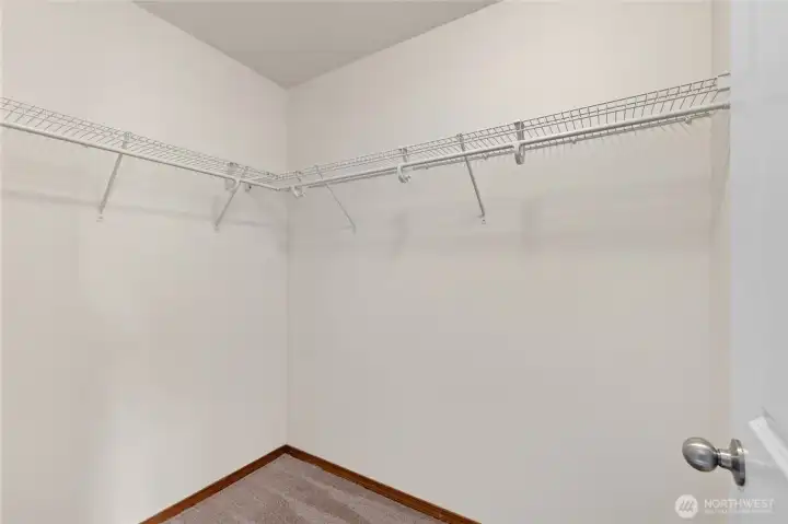 1 of 2 walk-in closets in primary