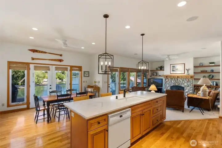Views from the kitchen to the water and easy access to the dining area. An entertainer's dream! Warm hardwood flooring and loads of light here