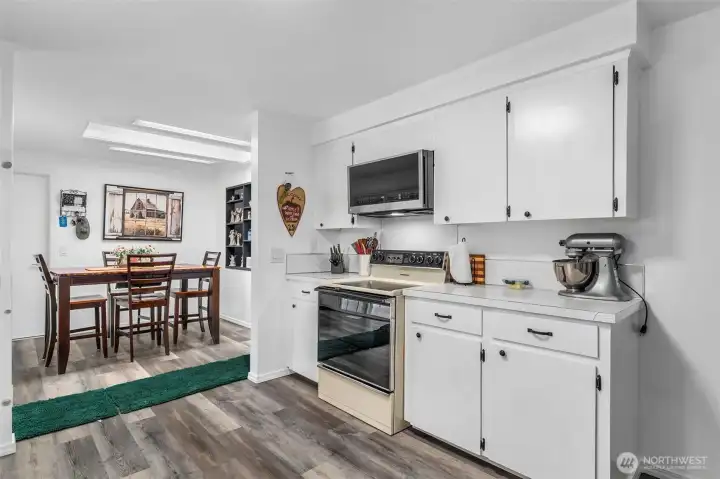 New laminate flooring extending through the kitchen space.