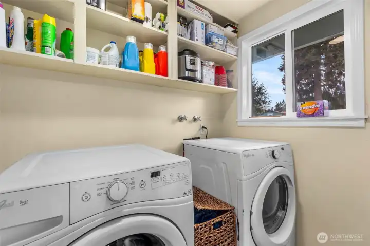 Dedicated laundry area with updated flooring.