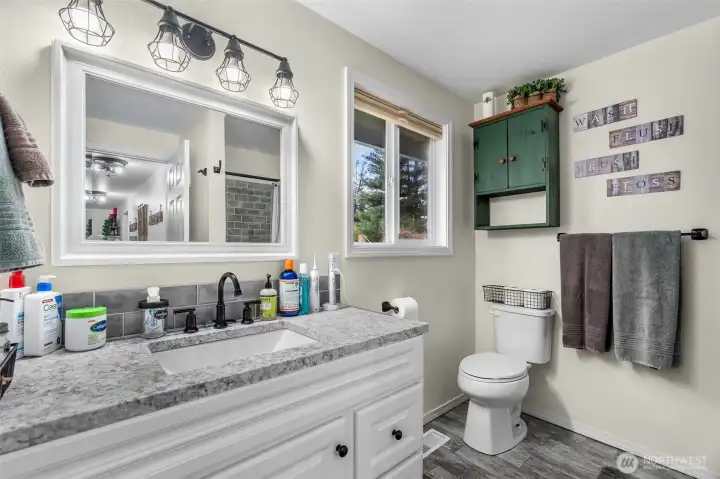 Updated full bathroom with stylish tile finishes.