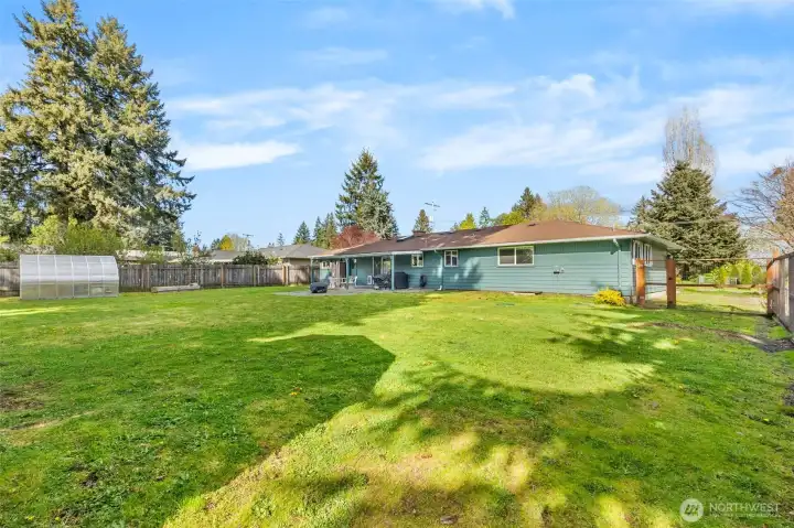 Expansive flat lawn ready for play, pets, or gardening.