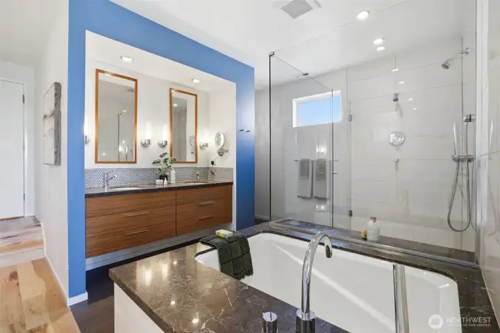 Double sinks with penny tile backsplash in the primary bath.