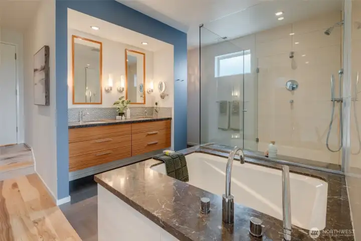 Double sinks, Japanese tub and a spacious tiled shower in primary suite.