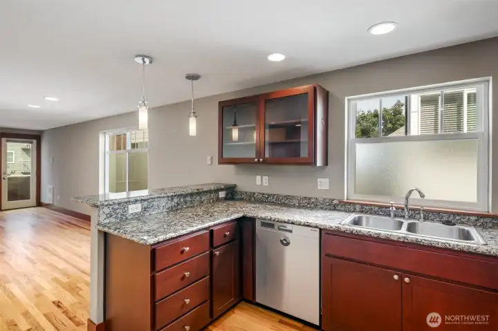 Kitchen with granite slab countertops.  New gas cooking range in 2025