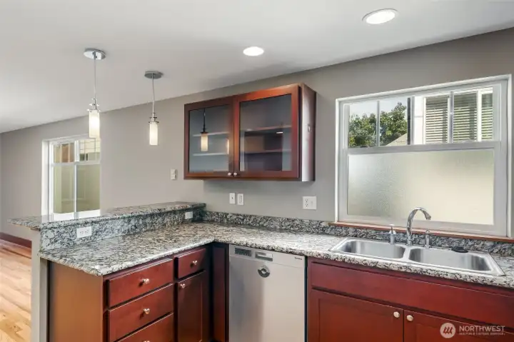 Kitchen with granite slab countertops.  New gas cooking range in 2025