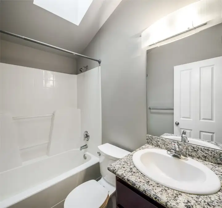 1st Primary Bedroom ensuite; full bath with slab granite countertop.