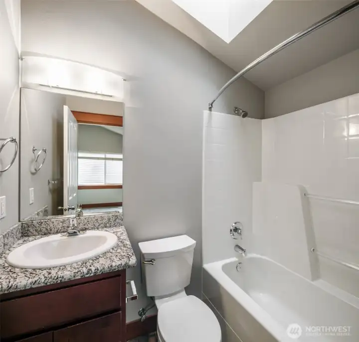 2nd Primary Bedroom ensuite; full bath with slab granite countertop.