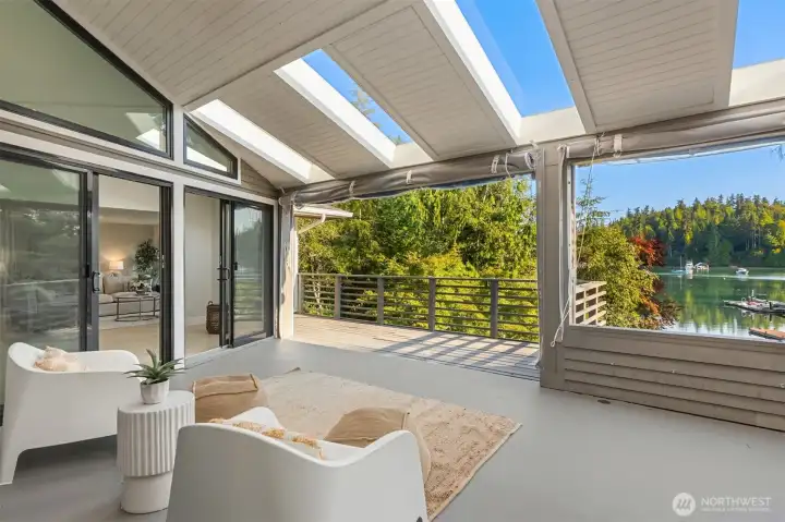 An unbelievable space! Through the slider is the home's Eastern Wing - an incredible primary suite deluxe or multi-generational quarters with a private entrance from the garage and main level of the home.