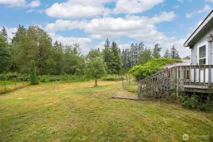 Looking across the back yard that is fenced.