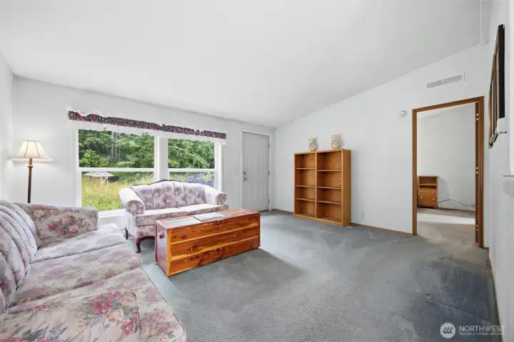 Looking toward the front entry of the home, which overlooks the rear yard and wooded area.