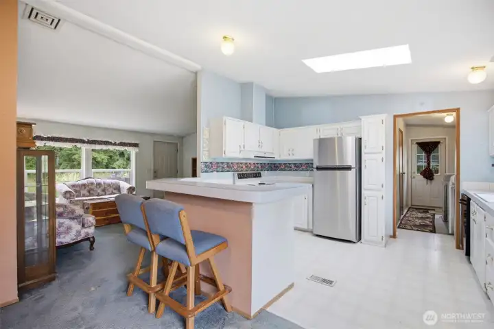 The kitchen is also spacious and open and has a large skylight that brings in the natural sunlight.
