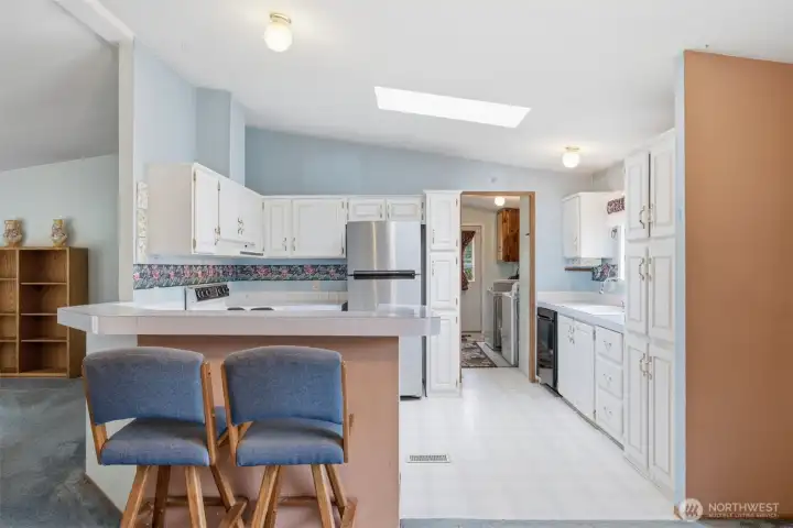 Looking across the kitchen toward the laundry room and back door.
