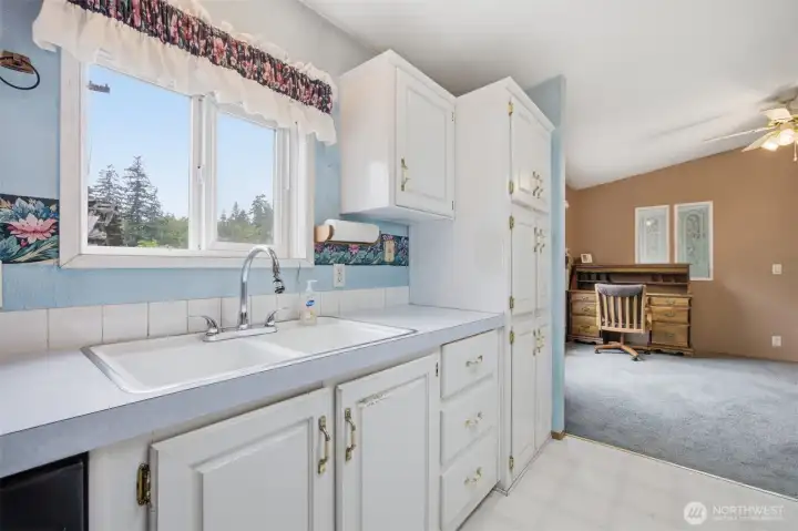 Another view of the kitchen with the dining room beyond.