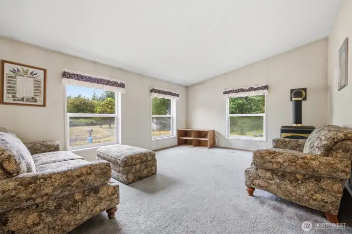 Looking across the family room which takes in the views of the acreage and driveway.