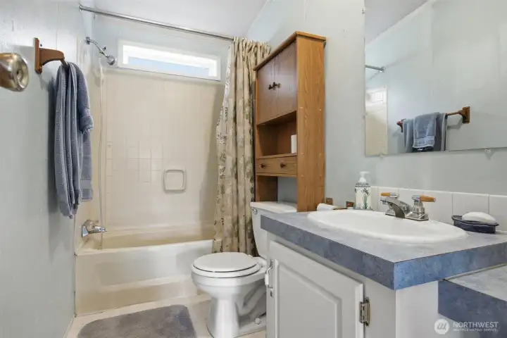 There is a full bath off the family room between the 2nd and 3rd bedrooms.