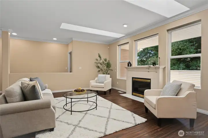 Cozy gas fireplace with serene greenspace views.