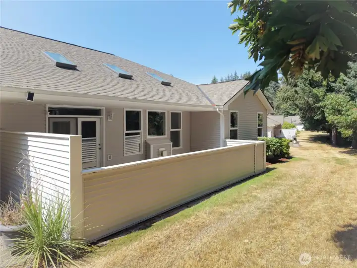 Updated half-wall for privacy and any pets. A back gate is at the corner.