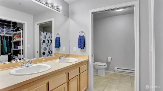 Primary en suite features double sink vanity separate from the water closet & shower, plus walk-in closet.