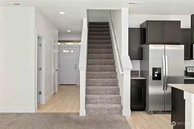 Fully carpeted staircase leading upstairs to 2 bedrooms, laundry and other bathrooms.