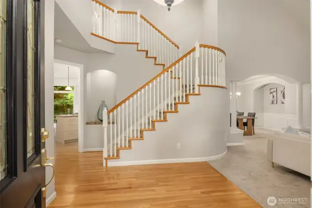 Grand entry with vaulted ceilings and bright interior.