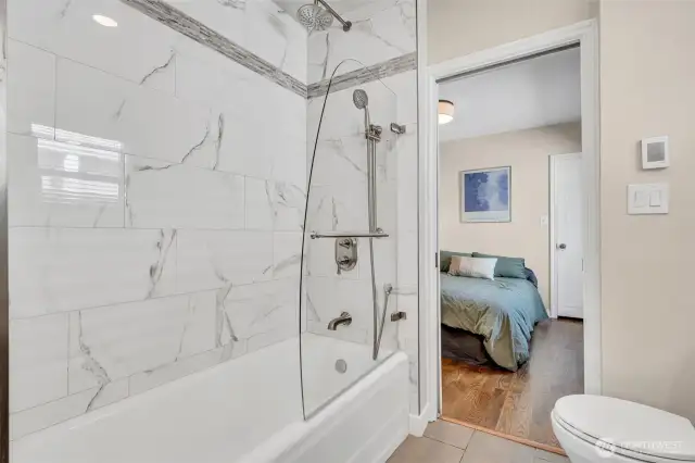 Main floor full bathroom with cast iron tub and radiant floor heat