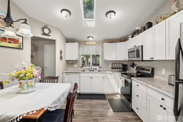 A Light & Bright Eat-in Kitchen! This Tidy Space Boasts Abundant Updated White Cabinetry, Countertops, and SS Appliances!